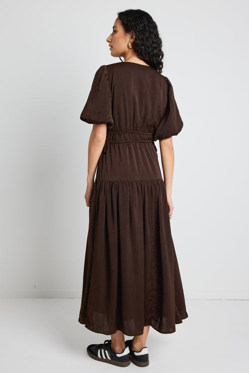 model wears brown satin maxi dress