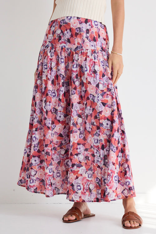 model wears a pink floral skirt