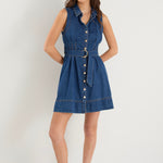 the model wears a blue denim mini dress with white sneakers