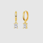 Gold hoop earrings with clear gemstones on a light gray background