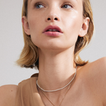 model wearing double chain necklace including pearl necklace and gold necklace with heart pendant