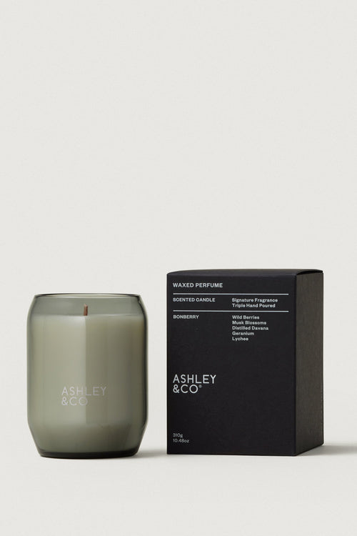 Candle and packaging of Ashley & Co on a light gray background