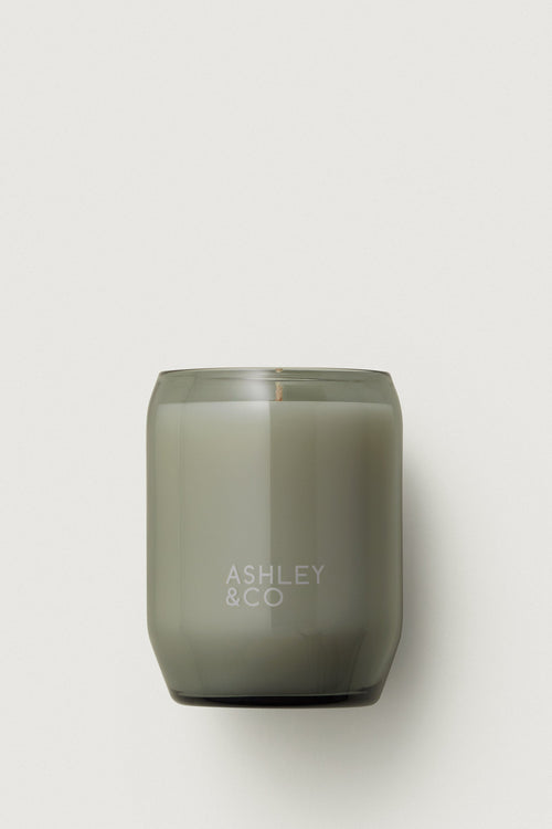 Gray candle with 'Ashley & Co' branding on a white background