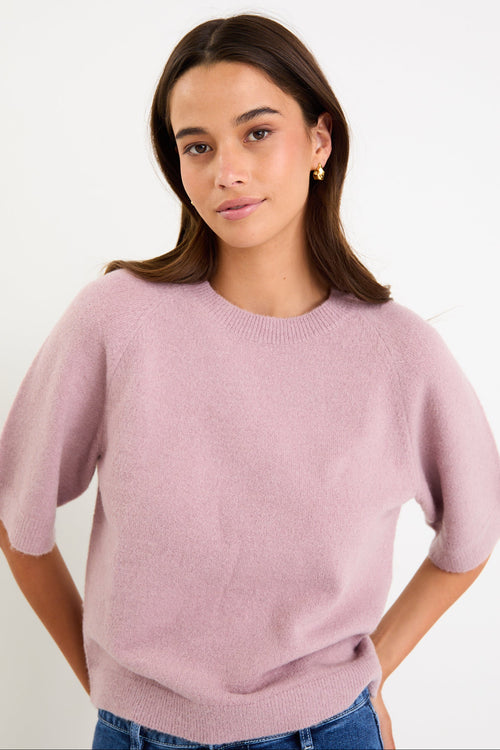 Model wearing a blush short sleeve raglan knit tee with a soft crew neckline and relaxed fit.