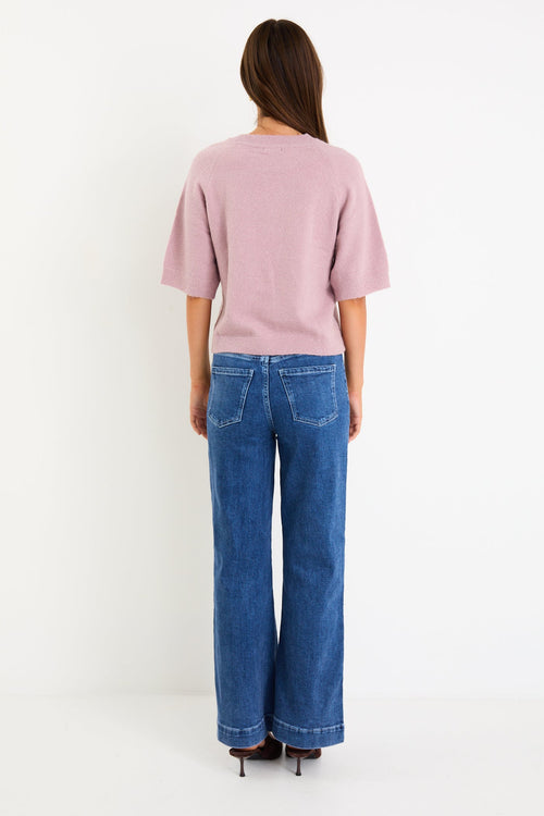 Model wearing a blush short sleeve raglan knit tee with a soft crew neckline and relaxed fit.