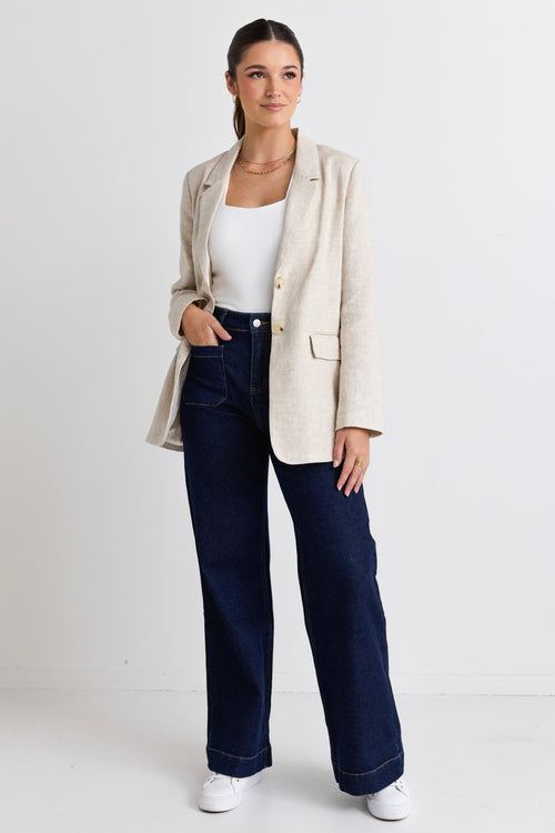 model wears a beige linen blazer