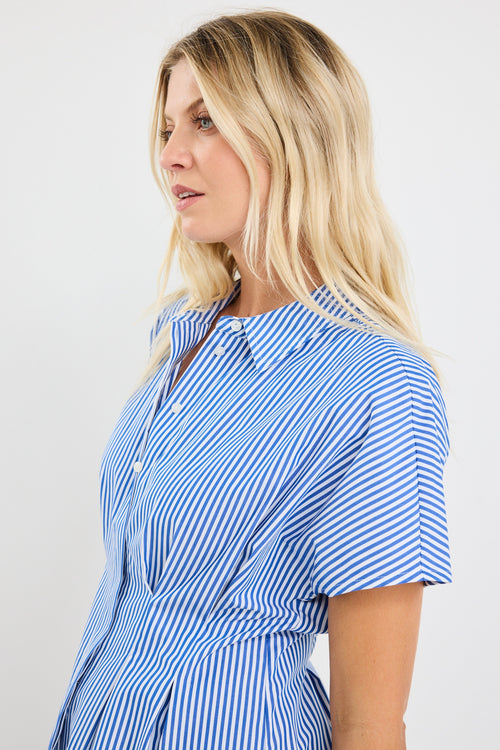 model wears a blue stripe corset blouse with blue jeans