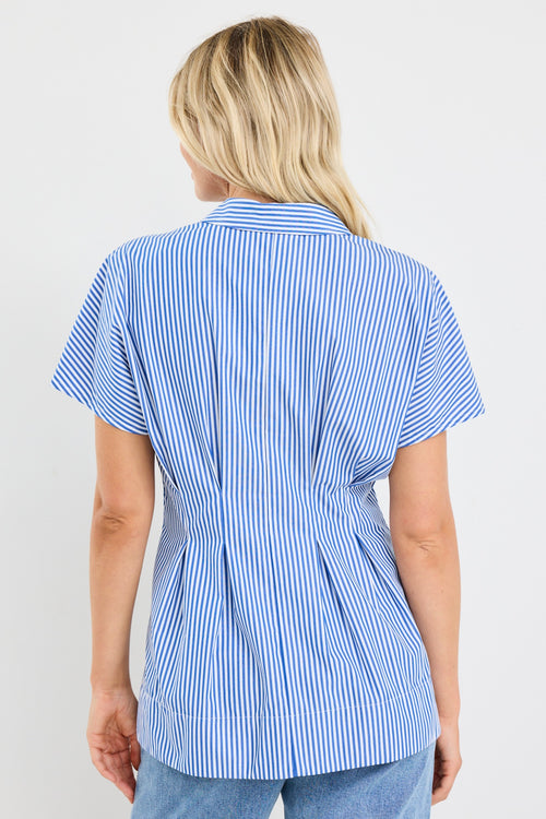 model wears a blue stripe corset blouse with blue jeans