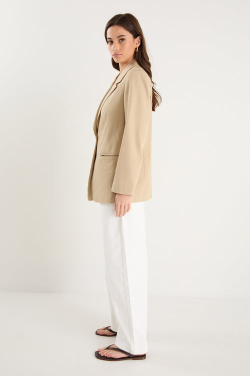 model wearing a beige blazer