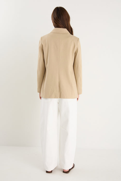 model wearing a beige blazer