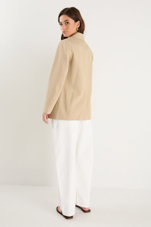 model wearing a beige blazer