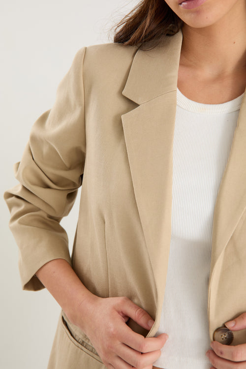 model wearing a beige blazer