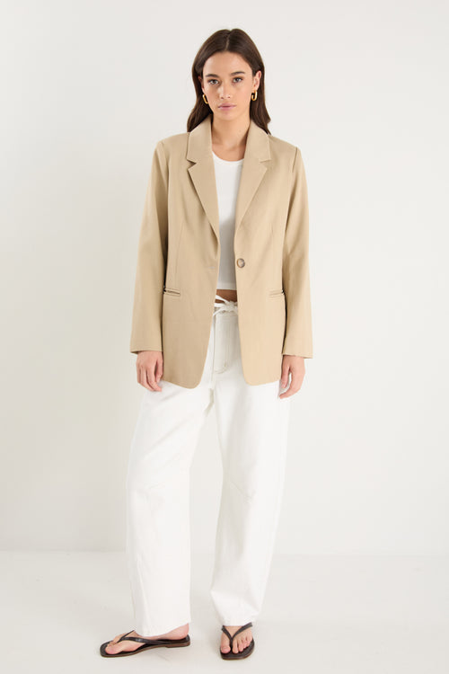 model wearing a beige blazer