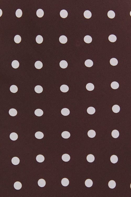 Close-up of a brown fabric with white polka dots