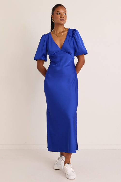 model wears a blue maxi dress