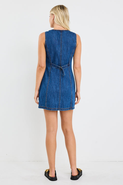 model wears a blue denim mini dress