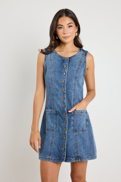 Model wears a denim mini blue dress 