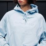 model wears a blue hoodie