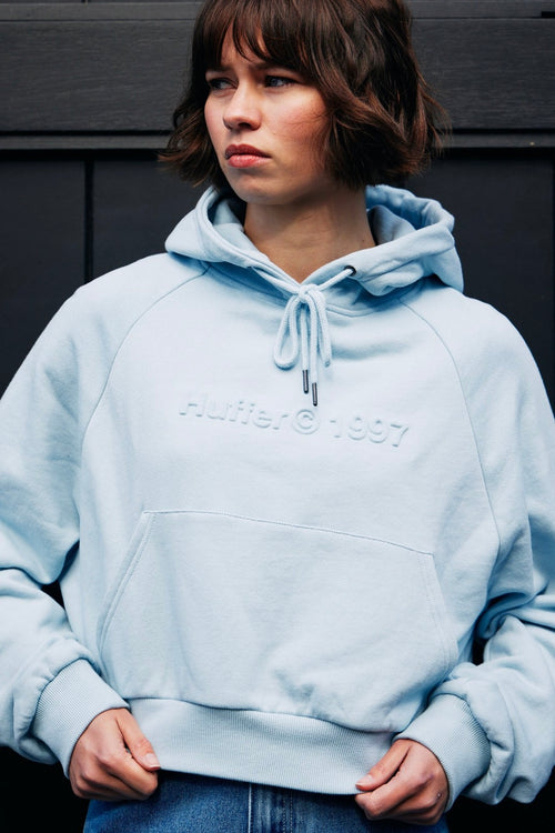 model wears a blue hoodie