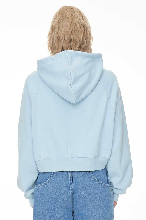 model wears a blue hoodie