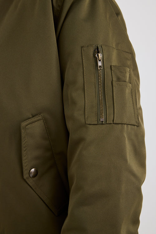 Model wears a khaki bomber jacket with black jeans and a white tee
col_pattern