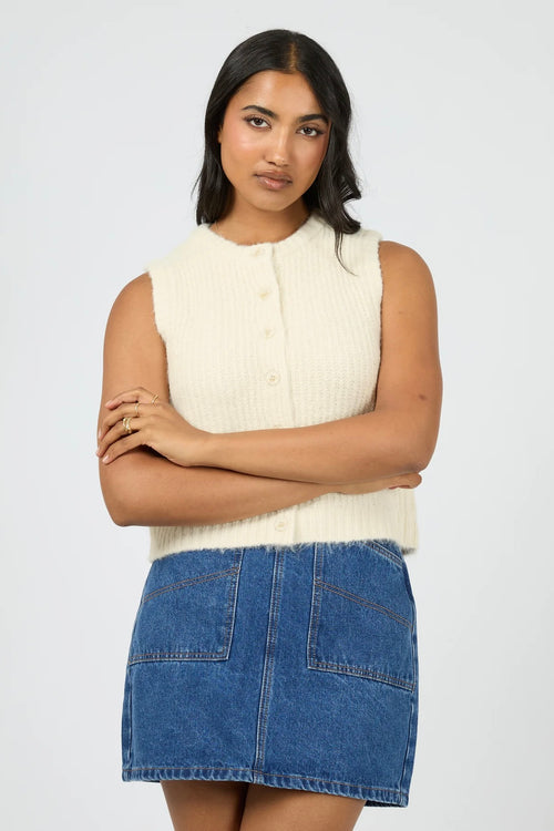 Model wears vanilla butter yellow knit button down vest. 