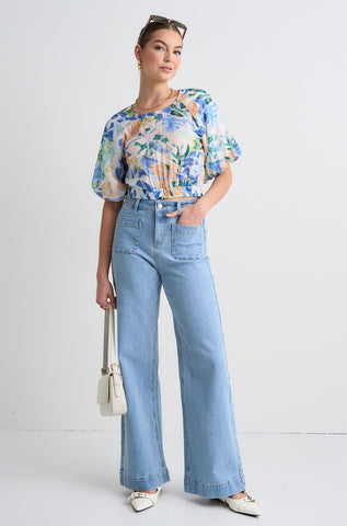 model wears a blue orange floral top