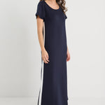 Woman wearing a navy dress with white stripes on a white background