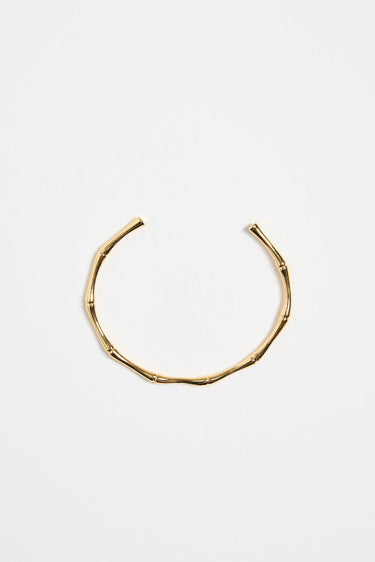 bamboo-inspired gold-plated cuff bangle with textured design, photographed flat against a white background.