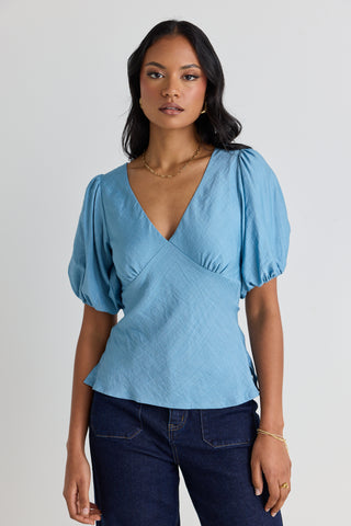 model wears a blue bias blouse