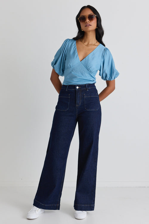 model wears a blue bias blouse