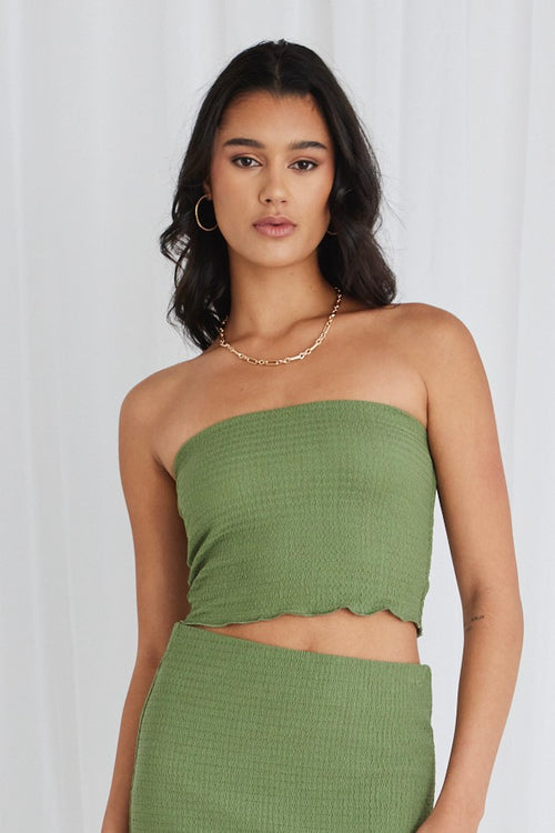 Model wearing green bandeau top and maxi skirt set