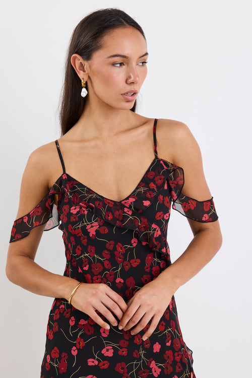 Woman wearing a black floral dress on a white background