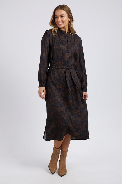 model wears a brown floral long sleeve midi dress