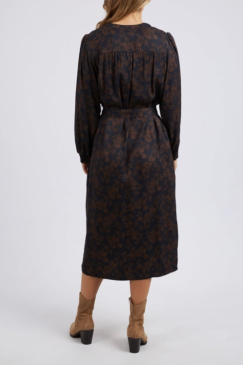 model wears a brown floral long sleeve midi dress