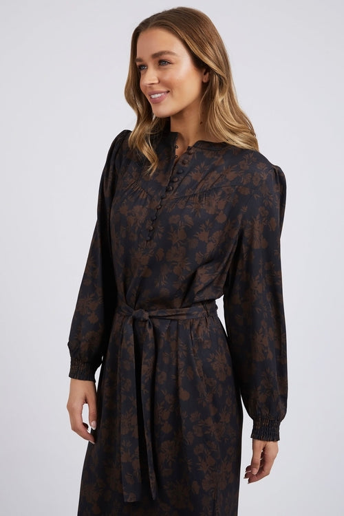 model wears a brown floral long sleeve midi dress