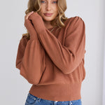 model wears a brown knit