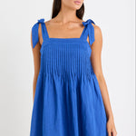 Woman wearing a blue ramie mini dress with bow straps