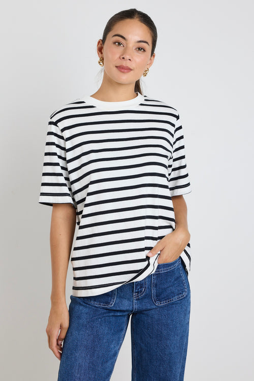 Model wears black and white stripe top with jeans