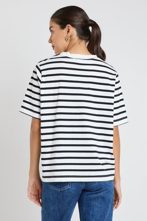 Model wears black and white stripe top with jeans