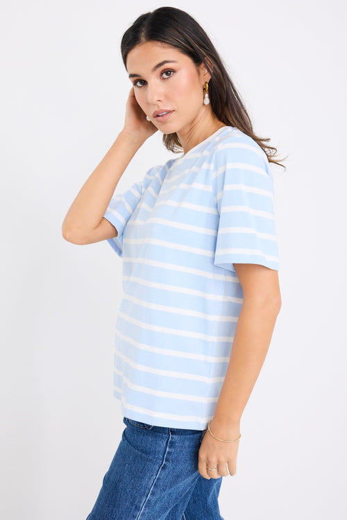 model wears a pale blue t shirt with white stripes