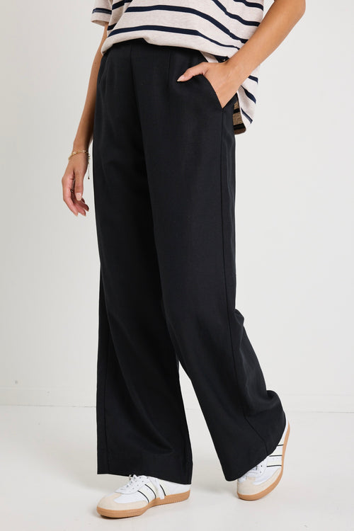 model wears a black linen pants