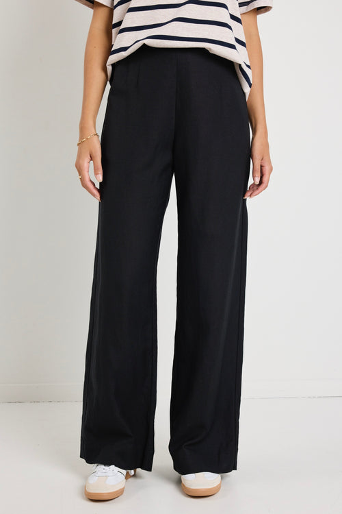 model wears a black linen pants