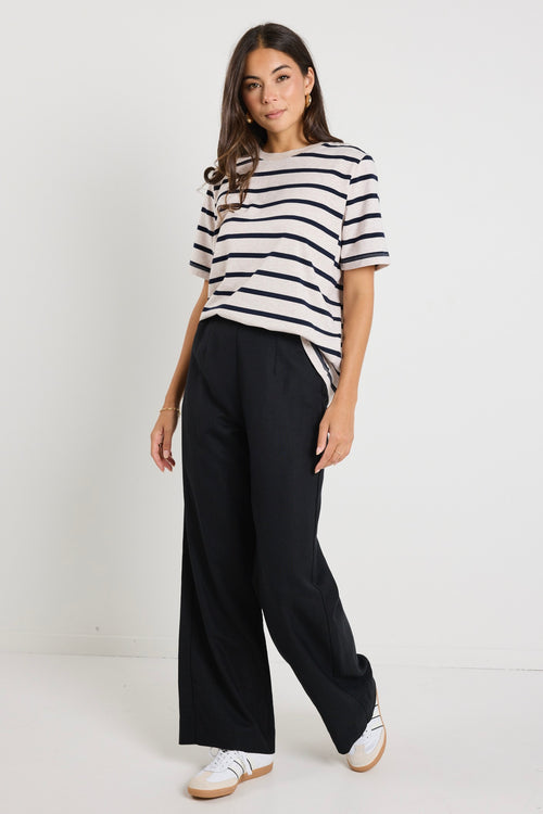 model wears a black linen pants