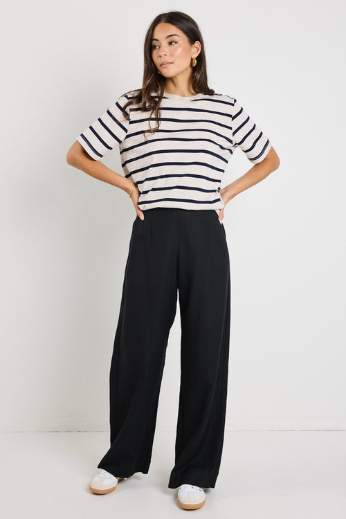 model wears a black linen pants