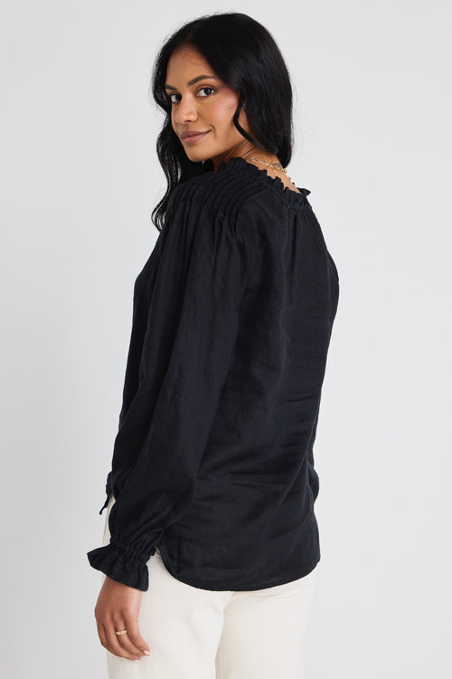 model wears a black linen long sleeve top