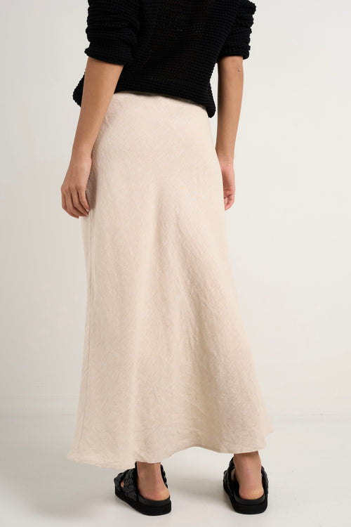 model wears a natural linen midi skirt