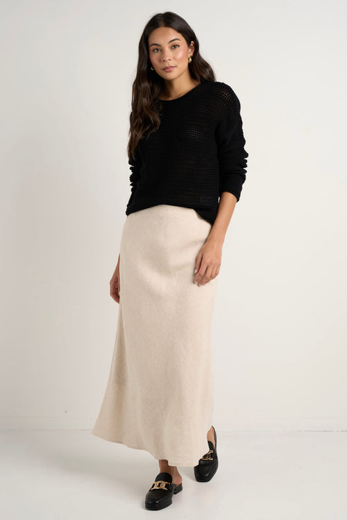 model wears a natural linen midi skirt