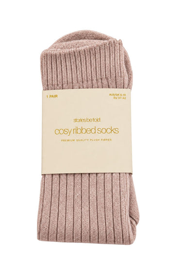 Blush pink cosy ribbed socks in Stories Be Told packaging, made with soft plush fibres.