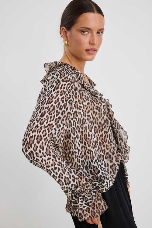 model wears a brown leopard with blue jeans